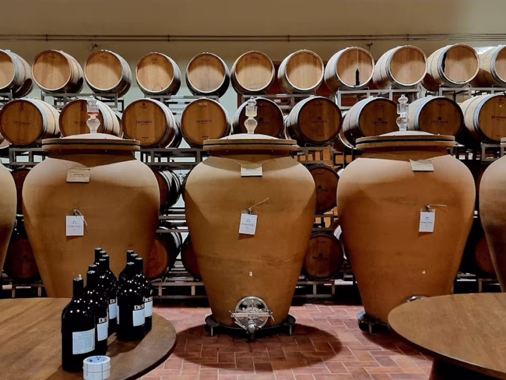 Large terracotta wine vats and oak barrels in a Prosecco winery near Venice, perfect for tasting tours.