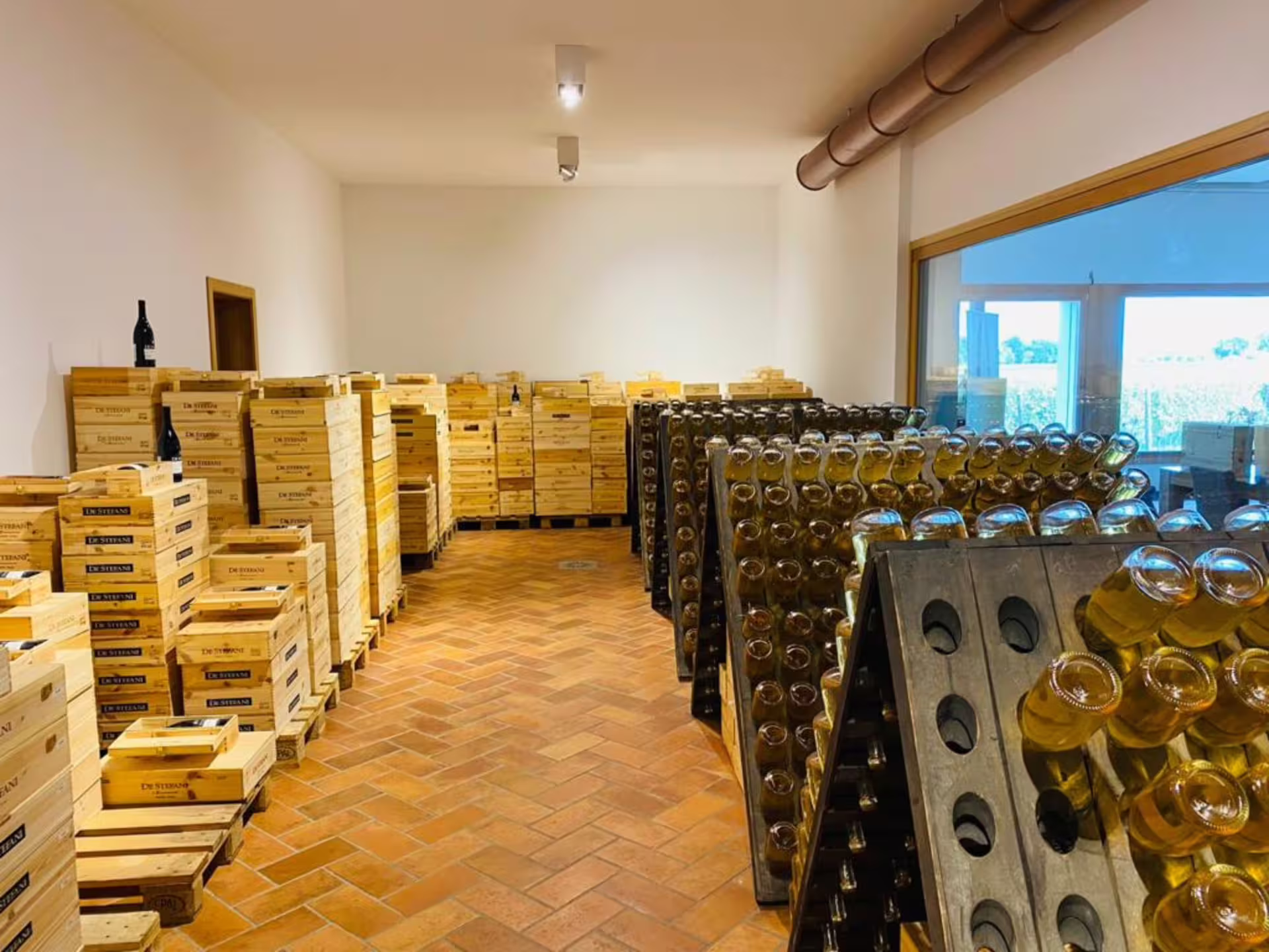 Wooden crates and wine bottles in a Prosecco winery near Venice, showcasing the wine aging process.