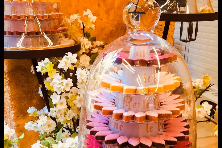 Colorful Provençal calissons and sweets under glass cloche, perfect treat on a leisurely Provence tour