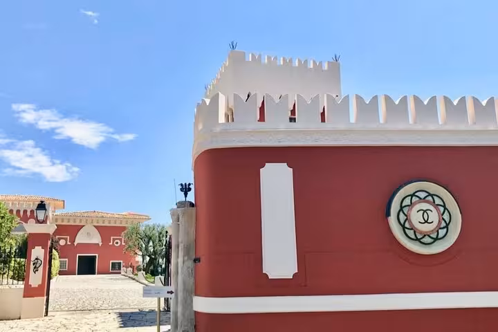Charming Provencal winery entrance under a clear blue sky, perfect for a countryside tour in Provence.