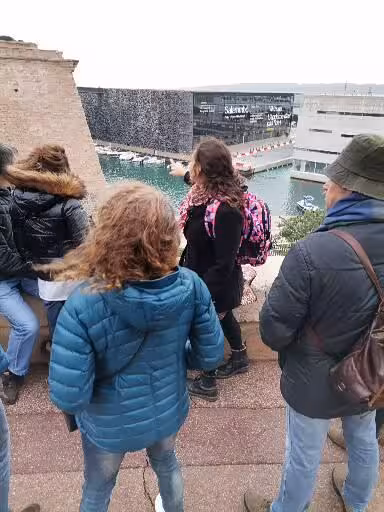Guided cultural walk on Provence Christian heritage tour overlooking Marseille waterfront and modern museum
