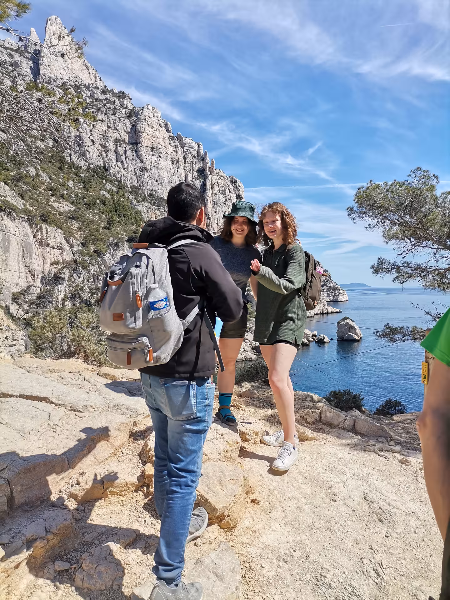 Hikers on rocky Calanques trail above the Mediterranean, guided Provence hiking tour with sea views
