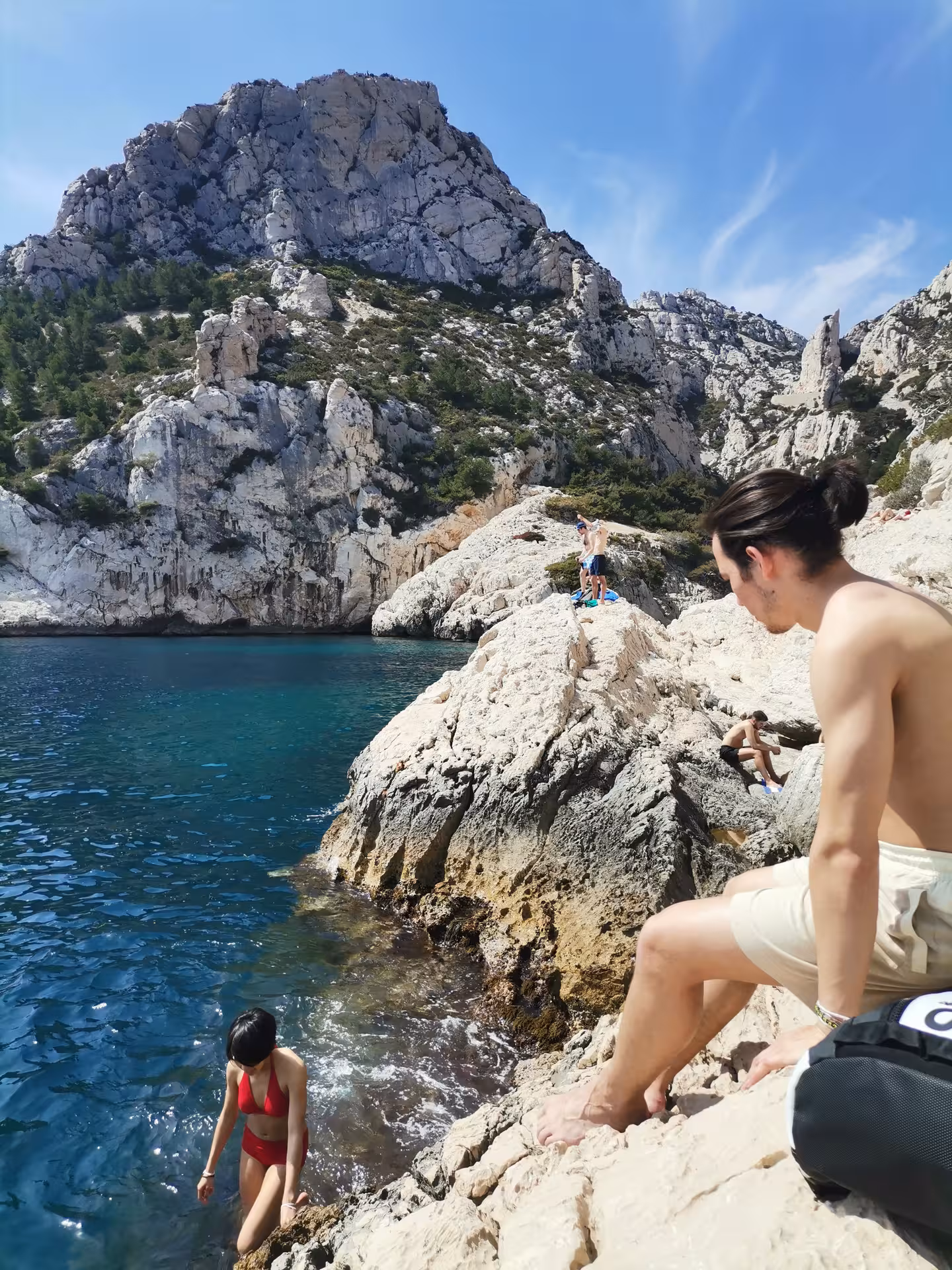 Swim break on the 7-day Provence hiking tour in the Calanques, with rocky coves and deep blue water