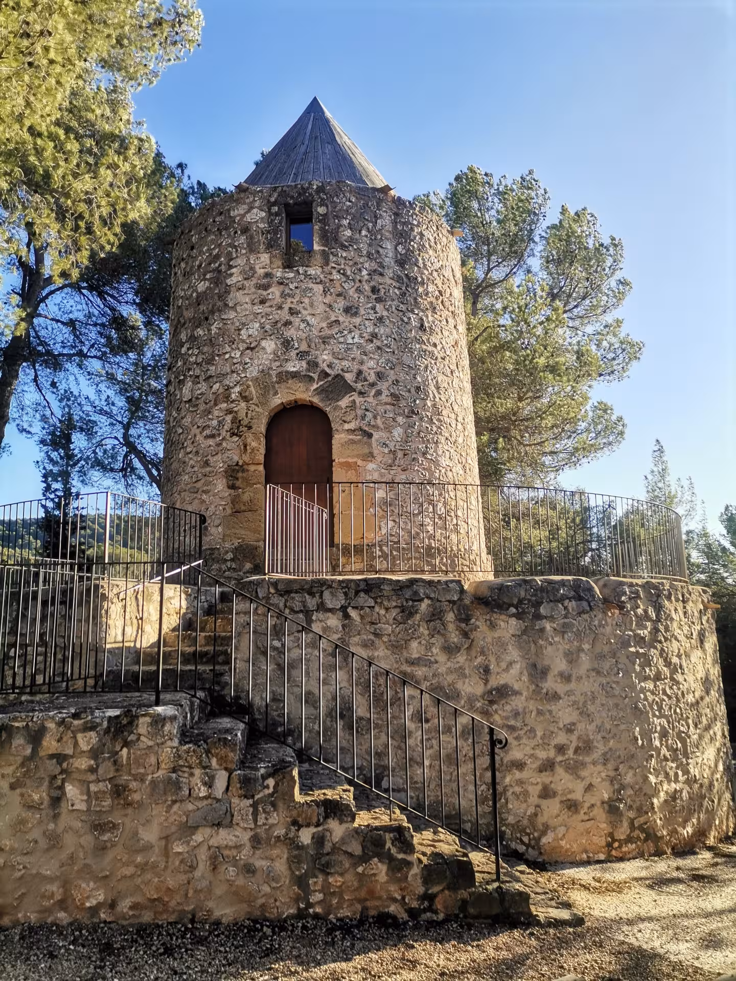 Historic stone watchtower in Provence on a cultural hike, sunlit forest setting during 14-day getaway