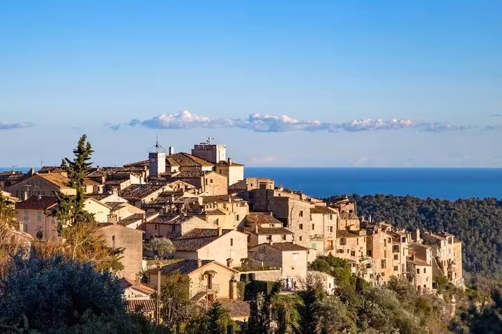 Panoramic view of a historic Provence medieval hilltop village with stone buildings overlooking the sea