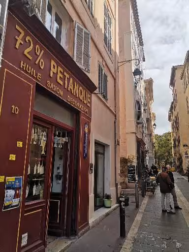 Provence old town street with local shopfronts, cultural walking tour stop on 7-day Christian heritage trip