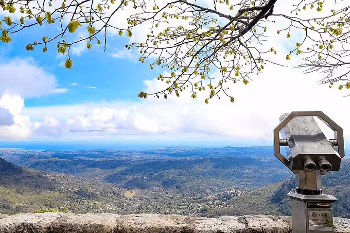 Panoramic viewpoint with coin binoculars overlooking lush Provence valleys and Mediterranean coastline on a private tour