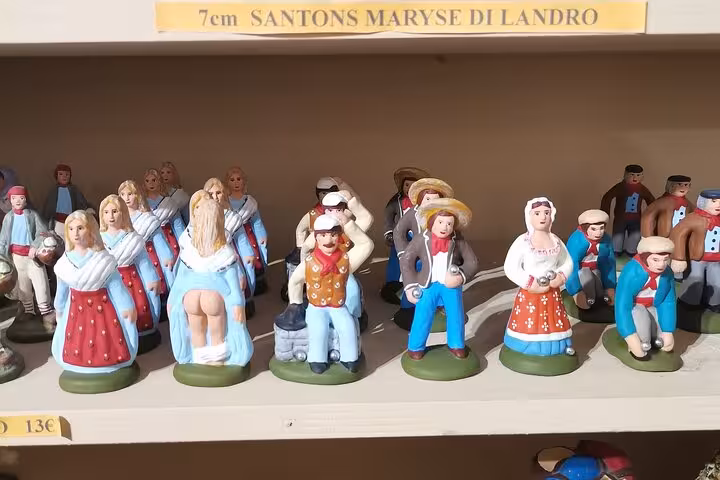 Provence private driver tour visit to artisan santons figurines shop, colorful traditional crafts on display shelf