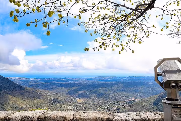 Panoramic valley view from Provence hilltop overlook with coin binoculars and Mediterranean coastline in distance