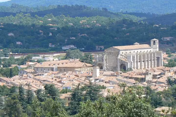 Charming Provence village with historic architecture surrounded by lush greenery, a highlight of a private day tour.