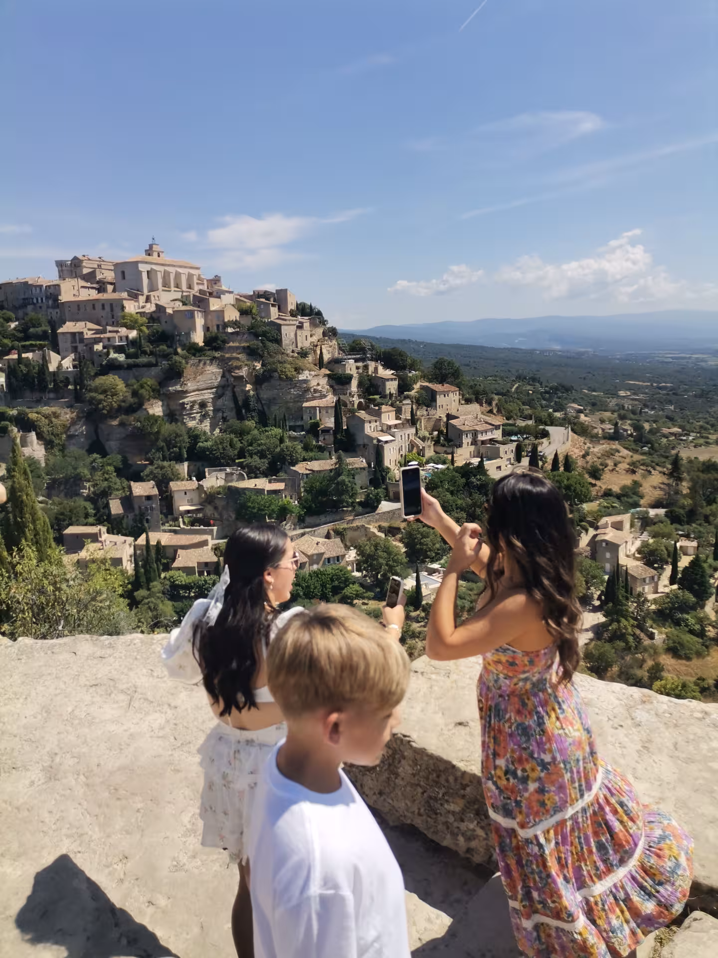 Travelers photographing a hilltop Provence village viewpoint on a Provençal Picnic Tour in the Luberon
