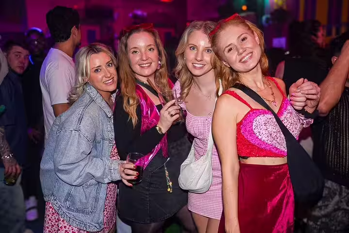 Group of friends enjoying vibrant nightlife on the Pub Crawl Madrid by Mad Party Crew, featuring lively bars and dance floors.