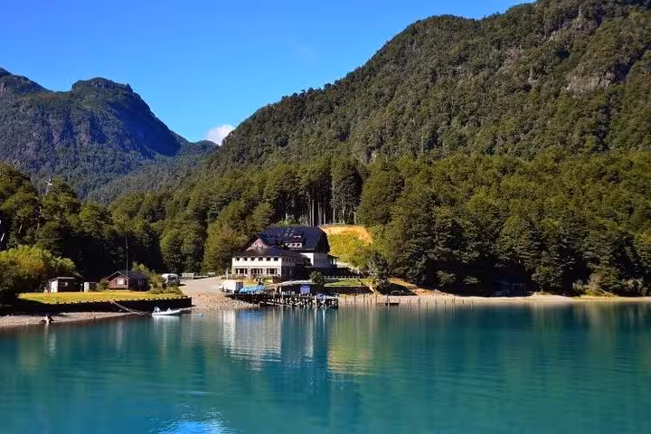 Vibrant turquoise waters of Lake Frías with scenic forest and mountain backdrop at Puerto Blest.
