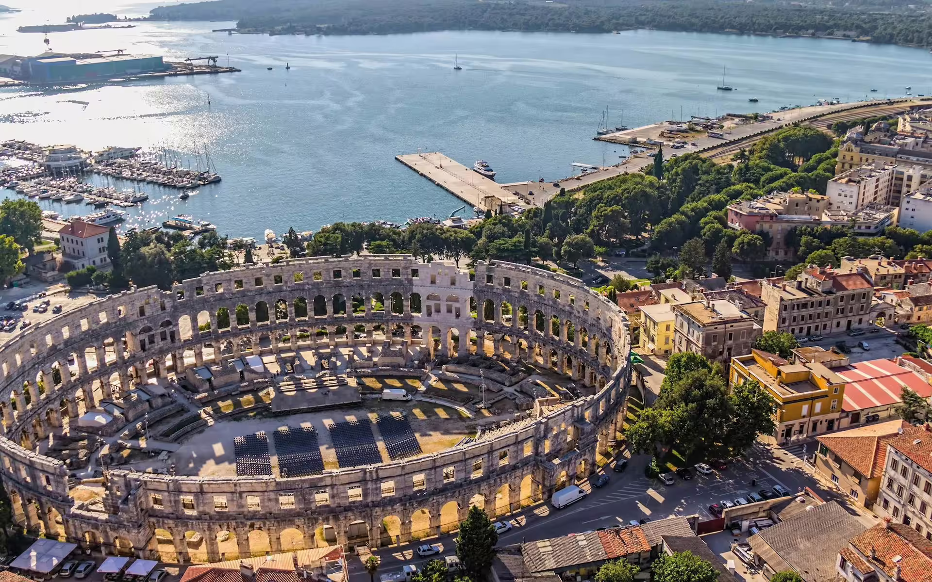 Aerial view of Pula Arena Roman amphitheatre and Adriatic harbor, highlight of Ancient Istria tour from Rovinj
