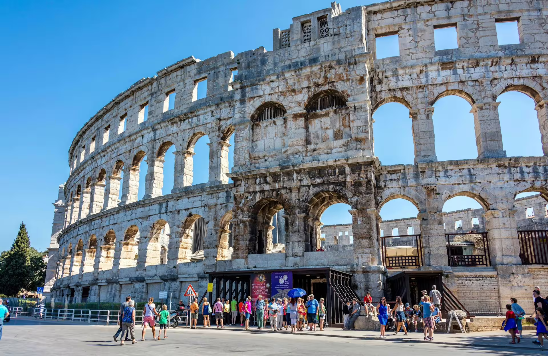 Pula Arena Roman amphitheatre with visitors, must-see stop on the Ancient Istria tour from Poreč