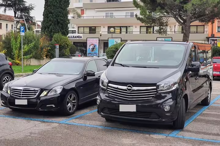 Luxury black sedan and spacious van parked for Puerto Vallarta Airport private arrival transfer service PVR