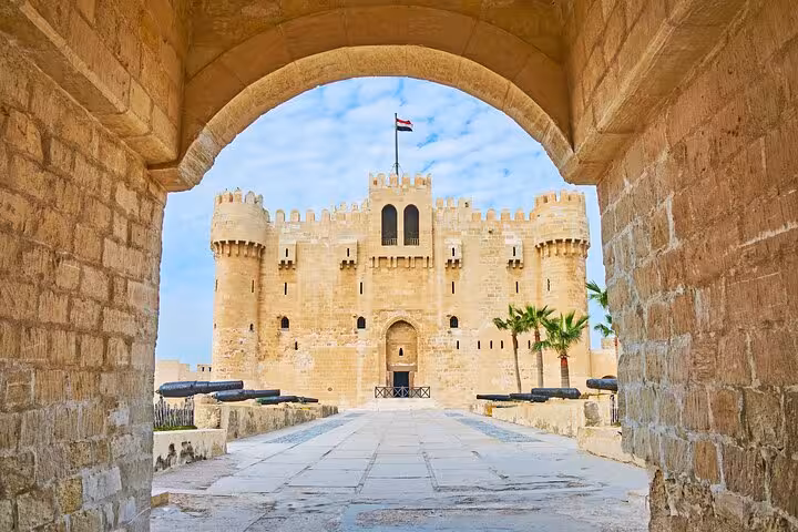 Qaitbay Citadel framed by stone arch in Alexandria, Egypt on 3-day private sightseeing tour from Cairo