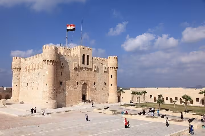Wide view of Qaitbay Citadel in Alexandria with Egyptian flag, included in 3-day private Cairo Giza Alexandria tour