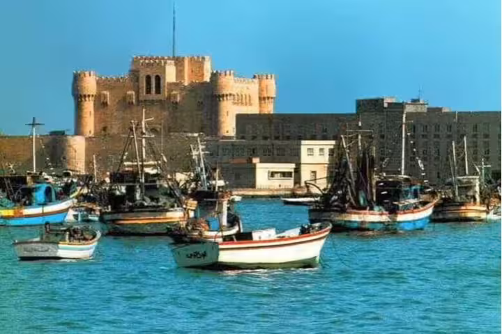 Fishing boats by Qaitbay Citadel on Alexandria harbor, scenic stop on a private Cairo to Alexandria tour