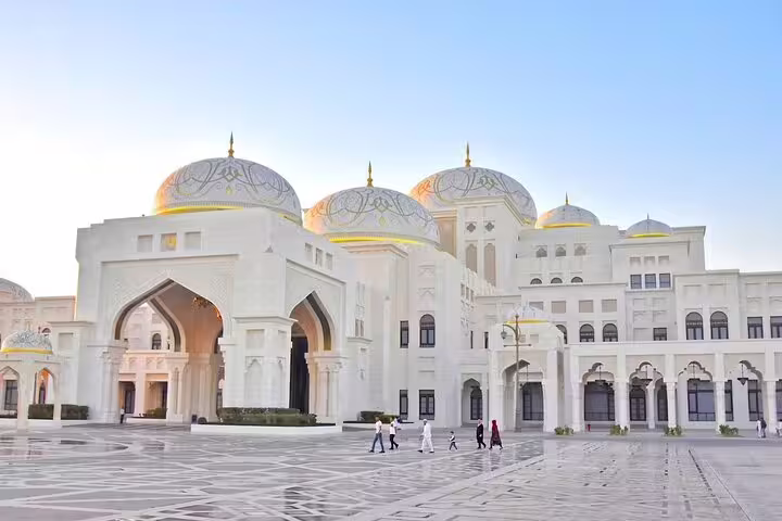 Majestic white domes and arches of Qasr Al Watan palace in Abu Dhabi at sunset, visited on guided cultural city tour