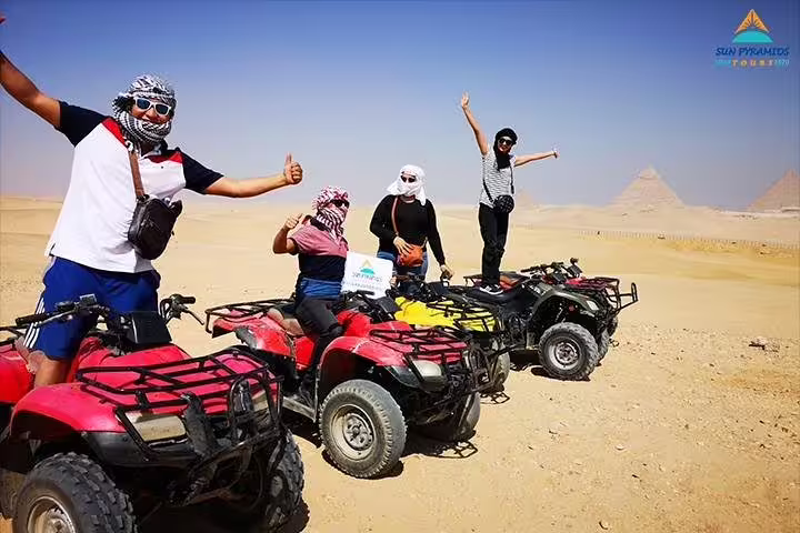 Group on quad bikes in Giza Desert with Great Pyramids backdrop, 1-hour sunrise or sunset safari tour