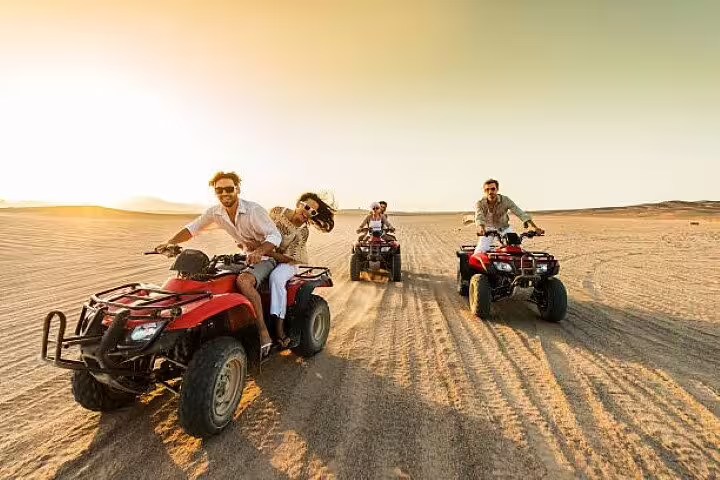 Group quad biking in the Sinai desert at golden hour on a private ATV safari adventure tour from Sharm El Sheikh