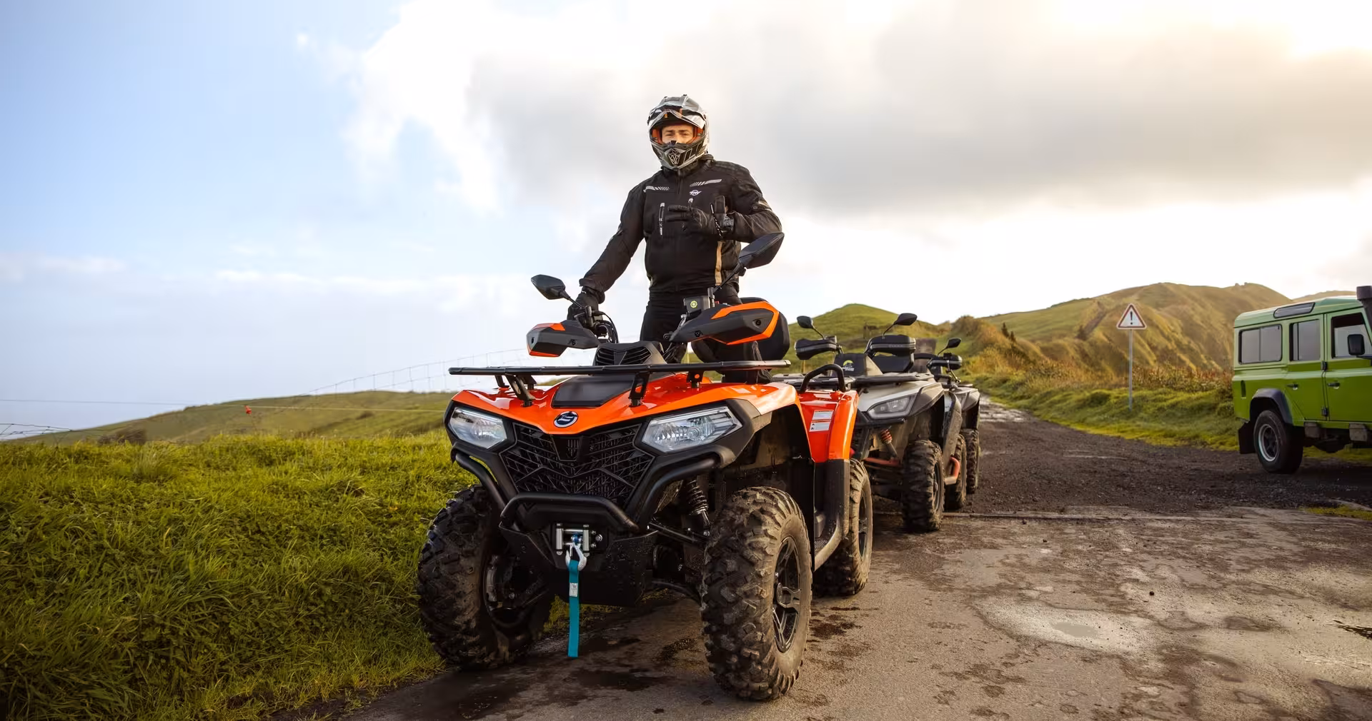 Rider on orange quad bike at scenic viewpoint on Half-day Quad Tour Seven Cities, São Miguel Azores