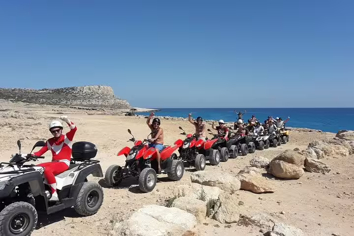 Group riding ATVs on Makadi Bay seaside desert trail, Red Sea views on private quad safari tour