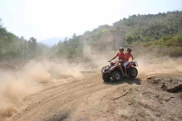 Cruise guests experience an exhilarating quad ride through dusty trails and scenic views near Kusadasi Port.