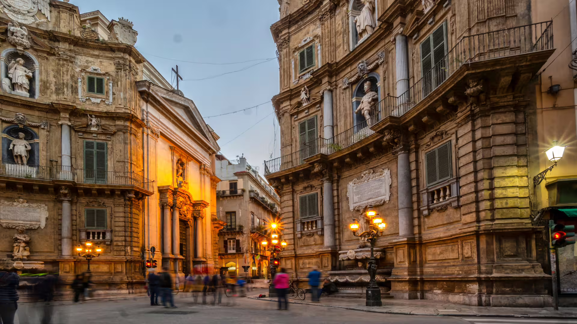 Evening view of Quattro Canti square in Palermo with Baroque palaces, statues and warm streetlights on a private city tour