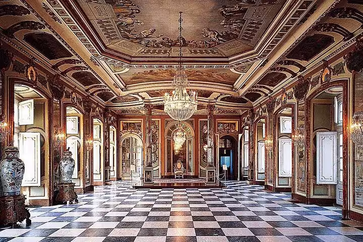 Elegant interior of Queluz Palace with ornate ceilings and chandeliers, featured in the Mafra, Ericeira, and Queluz tour.