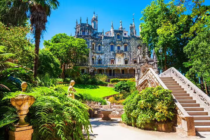 Stunning view of the lush gardens and ornate architecture of Quinta da Regaleira, a highlight on the Sintra day tour.