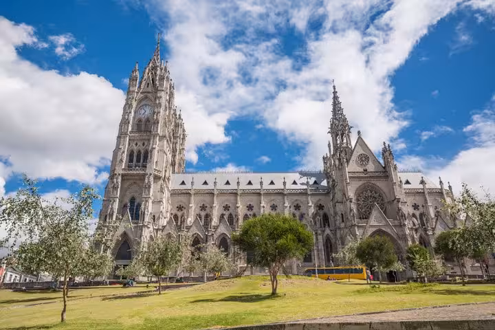 Basilica del Voto Nacional Gothic cathedral with clock tower in Quito Ecuador under blue sky