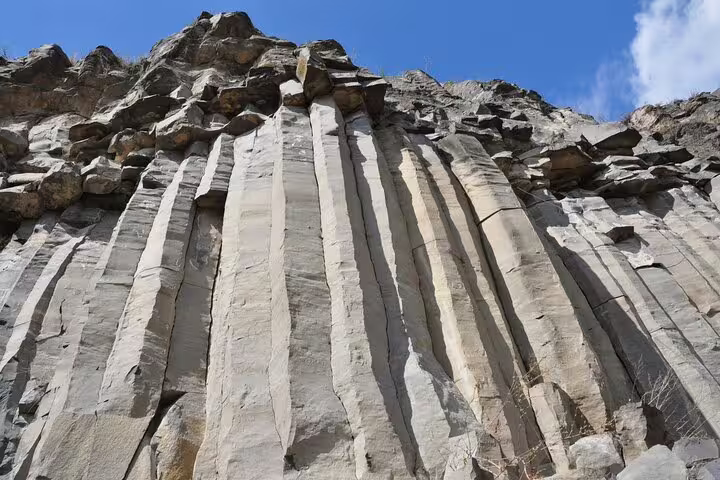 Tall basalt columnar rock formations at Racos volcanic gorge near Brasov, Romania