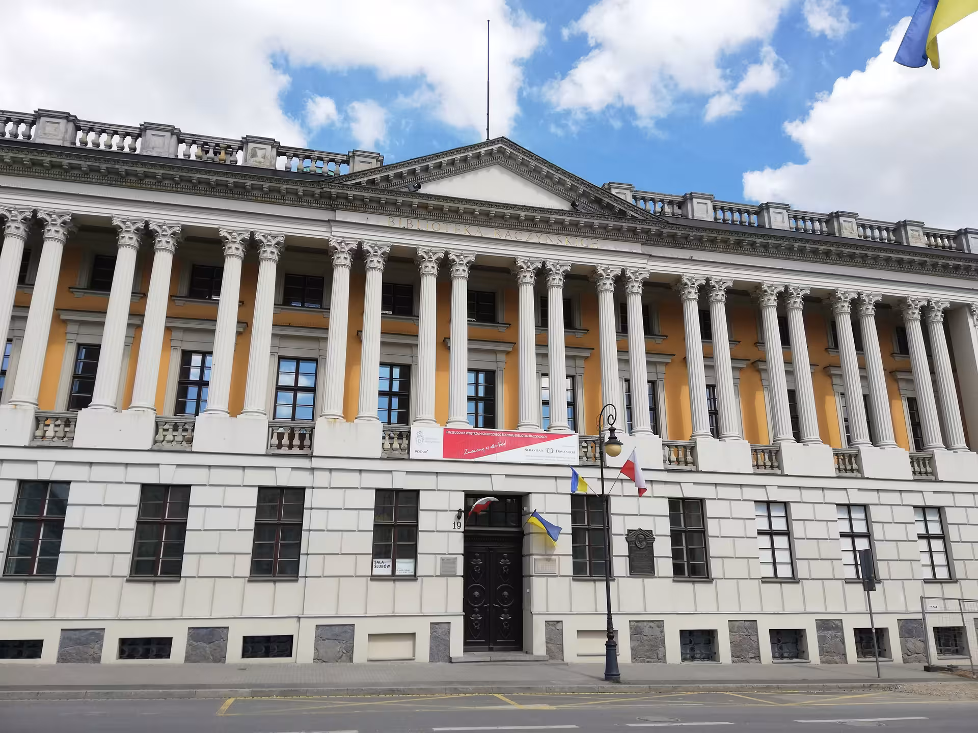 Historic Raczyński Library neoclassical facade with columns in Poznan Old Town city exploration game tour