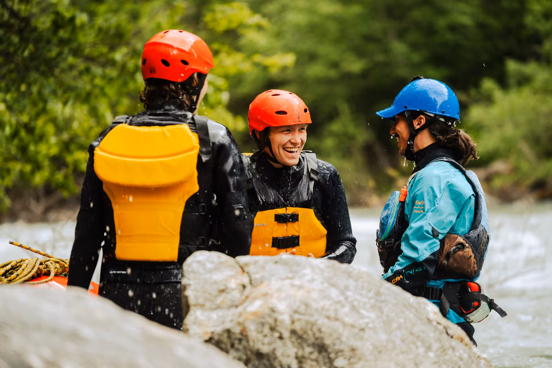 Rafting guide shares a laugh with excited participants, highlighting camaraderie during the Simme River adventure.