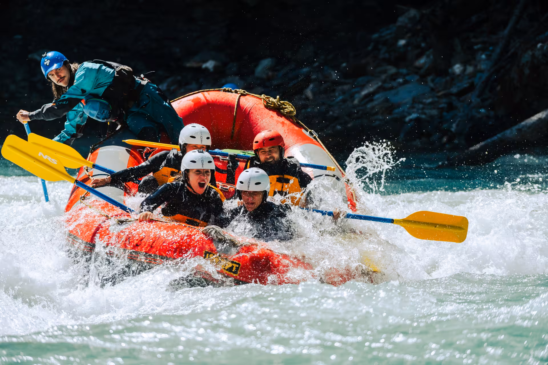 Excited rafters tackling whitewater rapids in Interlaken, capturing the essence of outdoor adventure and fun.