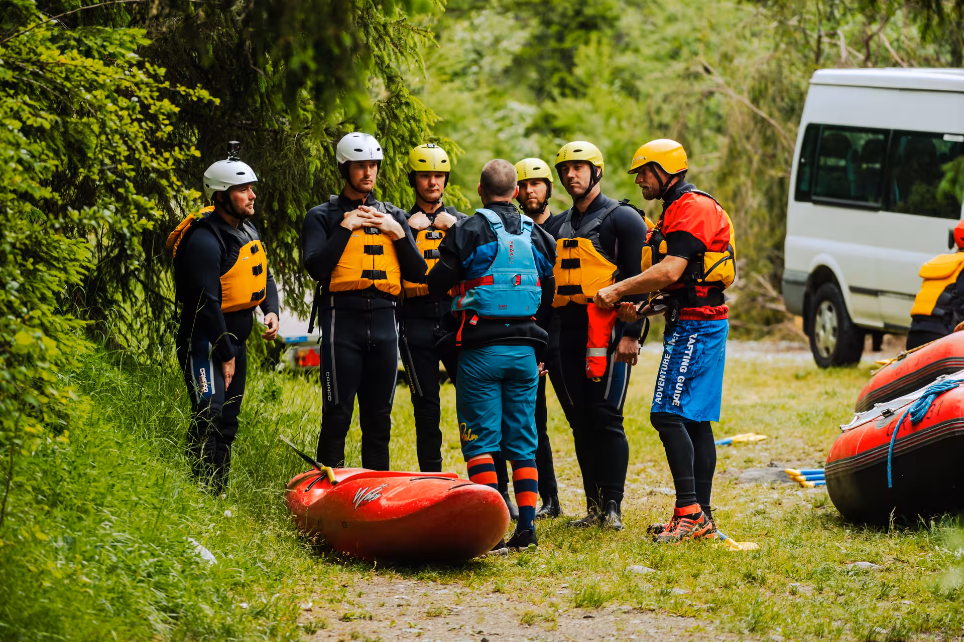 Group of rafters receiving safety briefing before embarking on an exciting whitewater adventure in Interlaken.