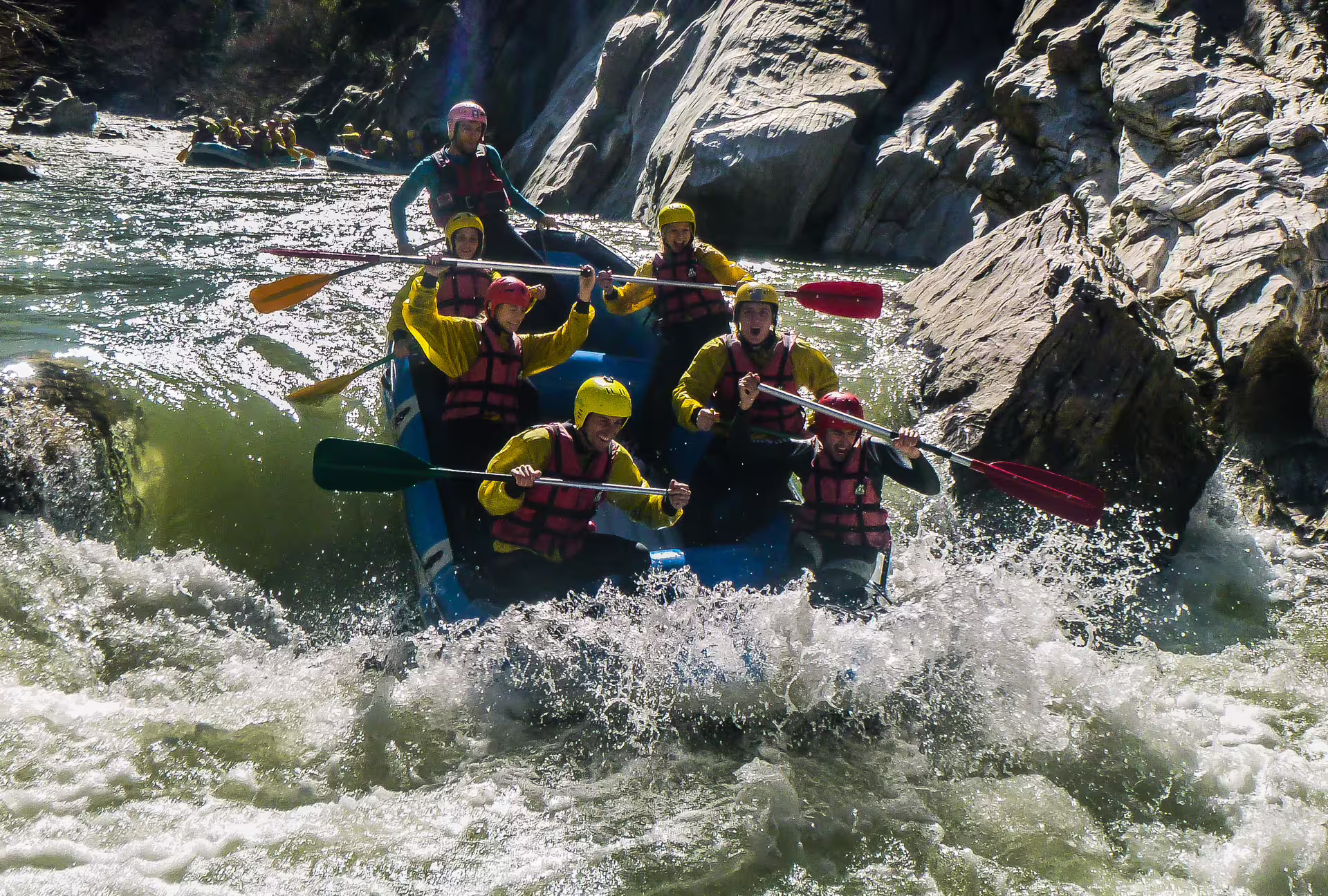 Raft hits whitewater rapids in rocky gorge on the Lousios and Alfeios rafting tour, Peloponnese Greece