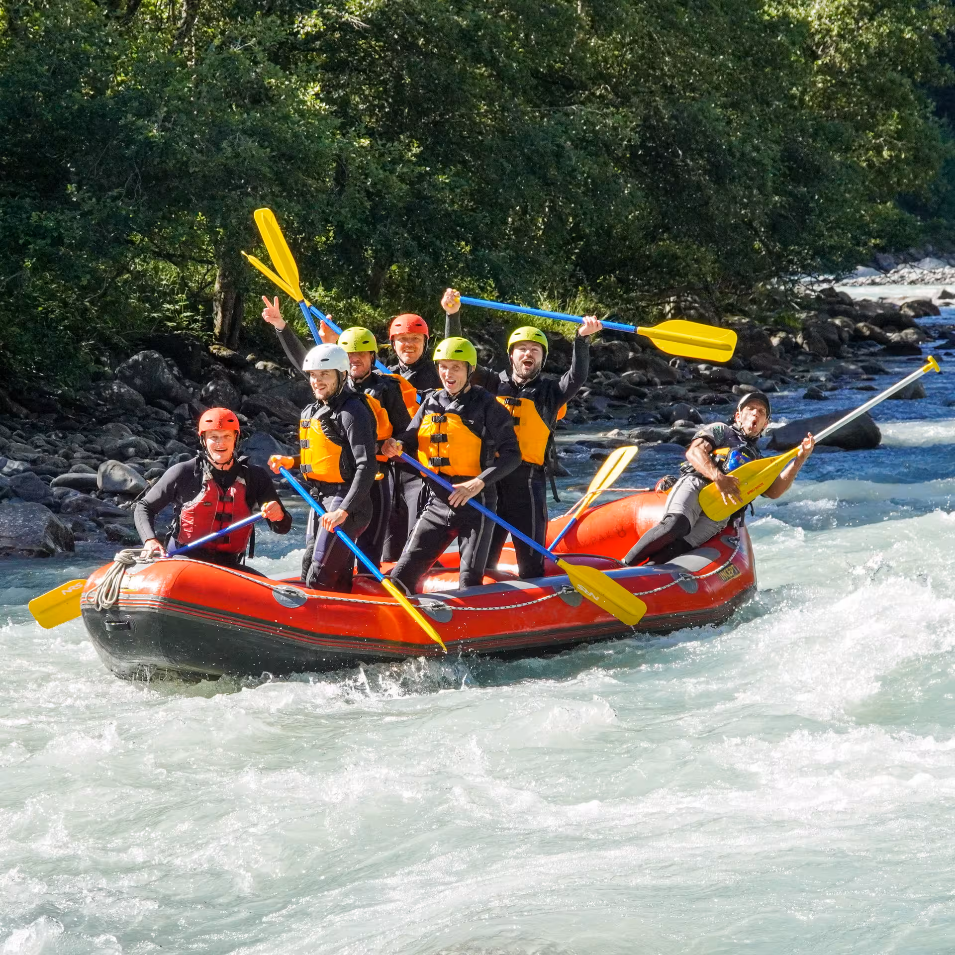 Group of rafters celebrating a successful ride on the Simme River, showcasing teamwork and adventure.
