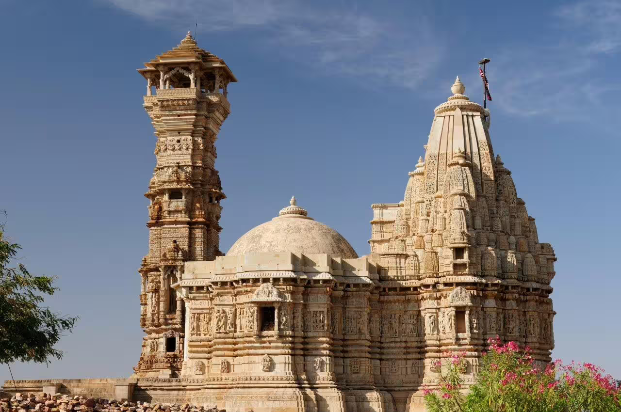 Intricately carved ancient temple under a clear blue sky, representing Rajasthan's rich architectural heritage.