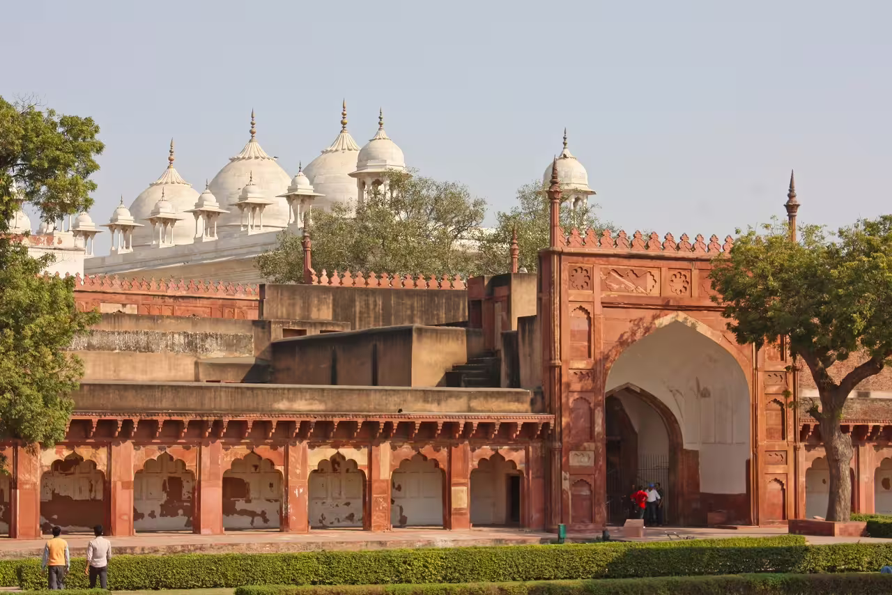 Historic red sandstone fort with intricate domes, showcasing Rajasthan's architectural heritage and cultural richness.