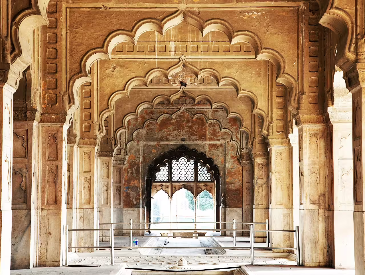 Intricate arches in a historic Rajasthan palace, showcasing Mughal architecture on a 14-day cultural tour.