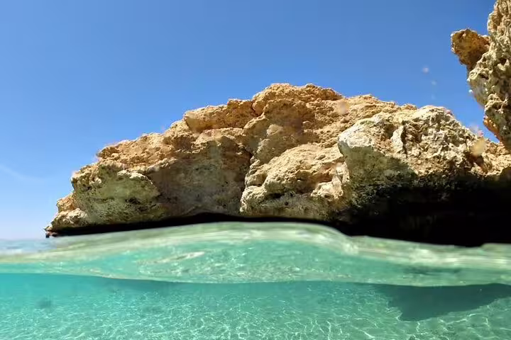 Crystal-clear shallow water and coral rock at Ras Mohammed National Park, Sharm El Sheikh half-day bus tour