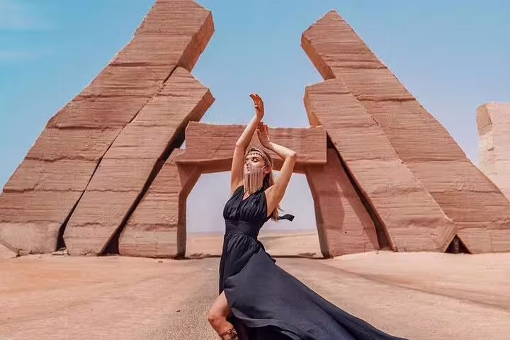 Traveler posing at Ras Mohammed National Park entrance monument, Sharm El Sheikh half-day tour by bus