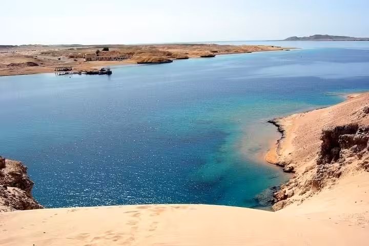 Turquoise lagoon and sandy cliffs at Ras Mohammed National Park, half-day bus tour from Sharm El Sheikh