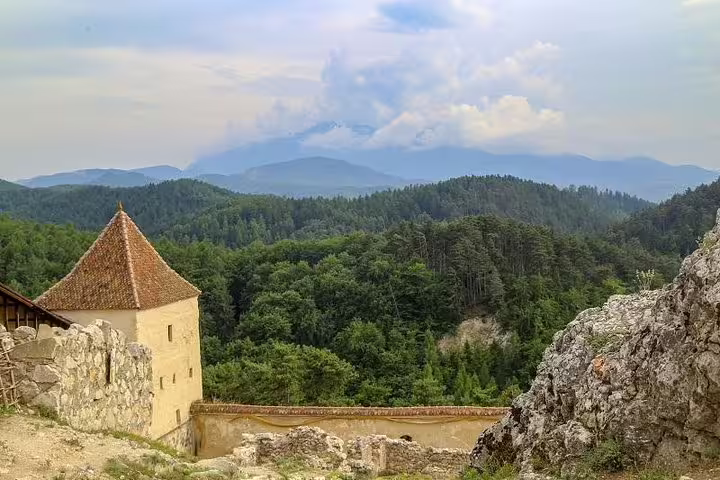 Rasnov Citadel tower with forested Carpathian mountains in background, Brasov region Romania
