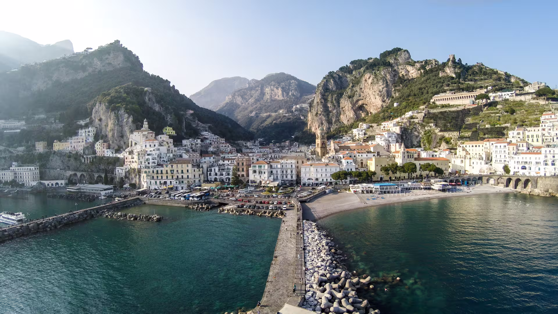 Panoramic view of Amalfi harbor and pastel cliffside houses on a Ravello Amalfi Coast tour along the Tyrrhenian Sea