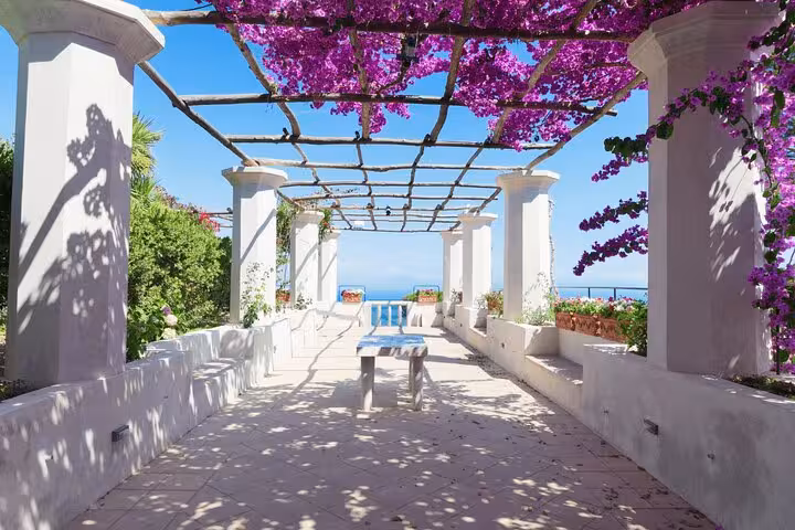Charming pergola in Ravello with vibrant bougainvillea and sea views, perfect for a half-day tour in Amalfi Coast.