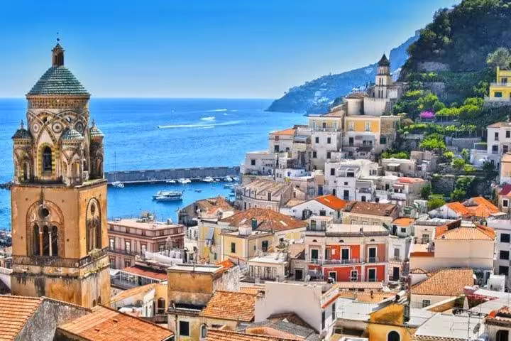 Panoramic view of Ravello's historic architecture and vibrant coastline overlooking the Tyrrhenian Sea, Italy.